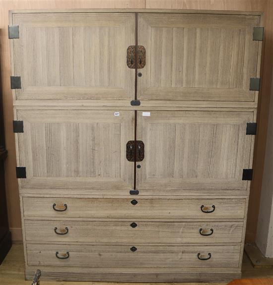 A Japanese paulena wood three part cabinet / linen press, W.167cm